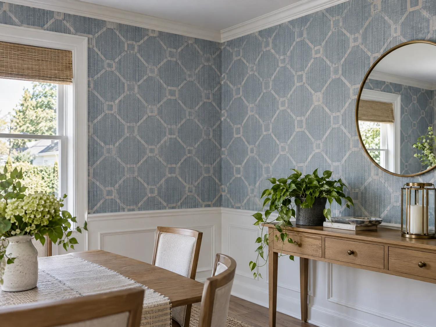 A quiet dining-room corner with blue-grey geometric wallpaper meeting white trim